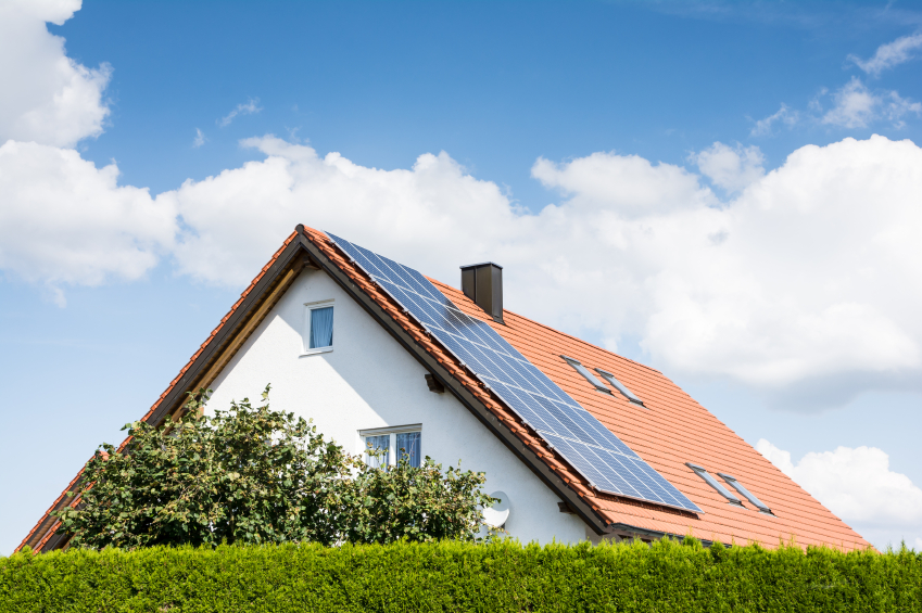 Modern house with photovoltaic solar cells on the roof for alternative energy production